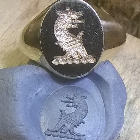 blue tack impression from laser crest engraved signet ring
